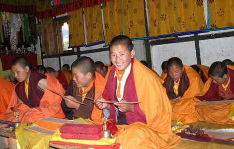 Students reading pechas and smiling